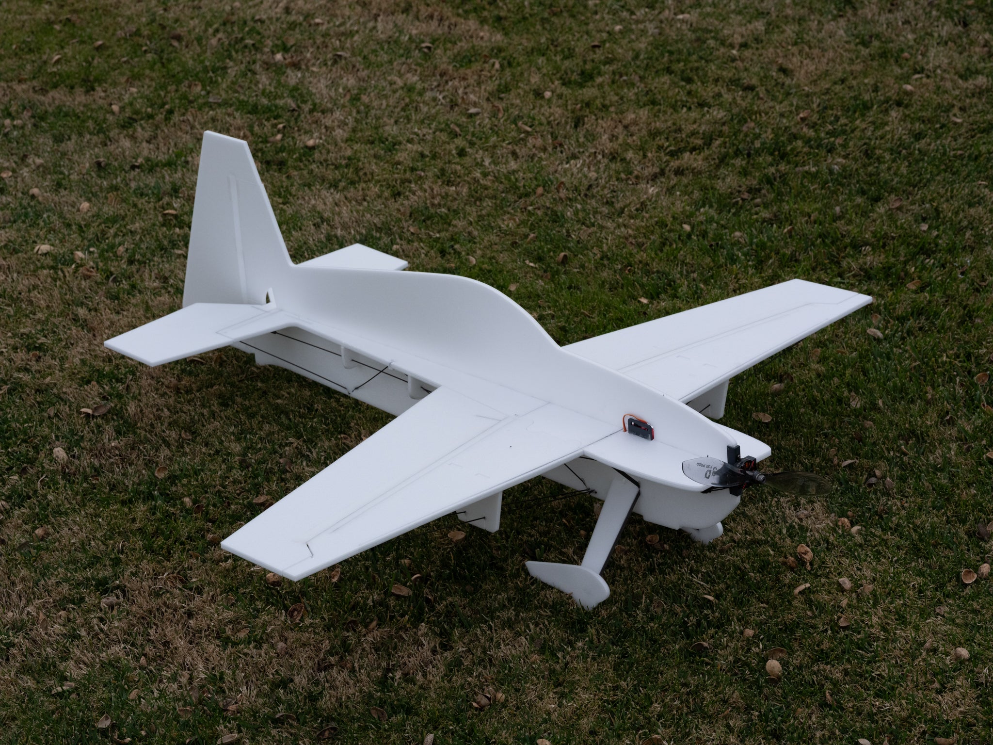 White model airplane on grass