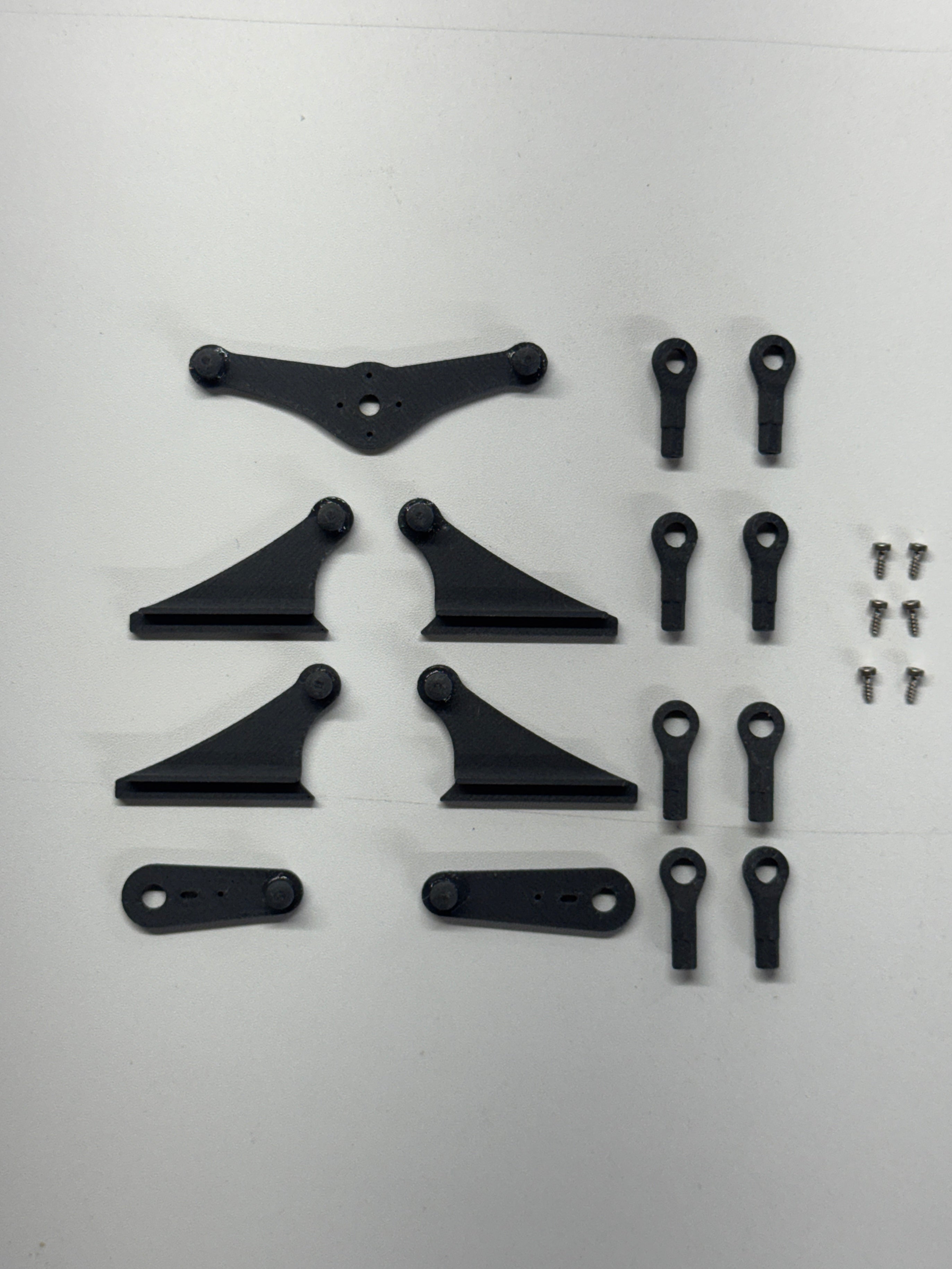 Set of black mechanical parts on a white background